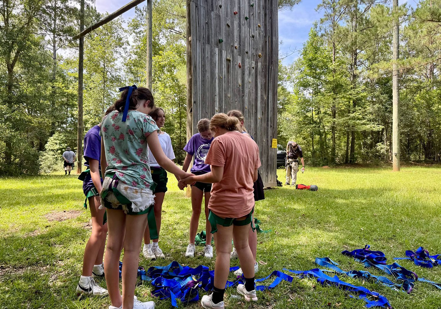 Campers praying in a circle outdoors